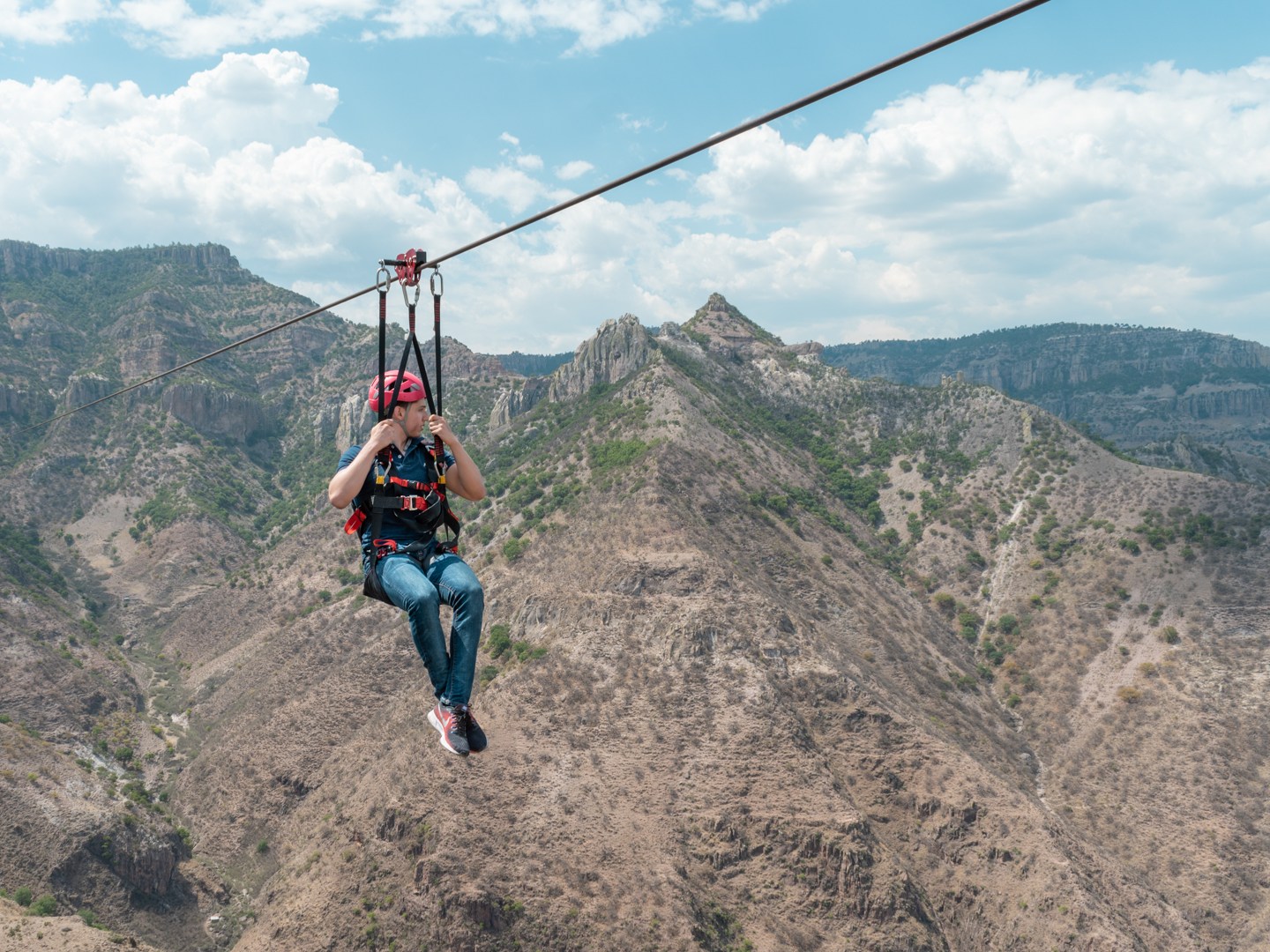 a man flying through the air while riding a bike down a dirt road