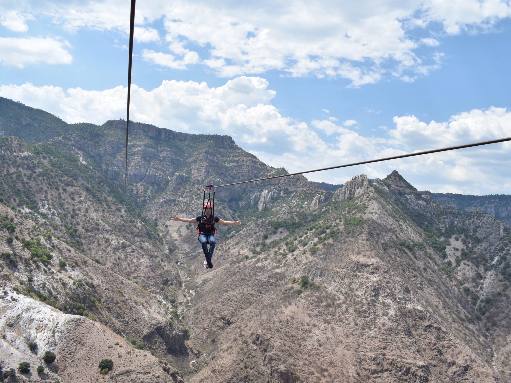 a man standing on a rocky hill
