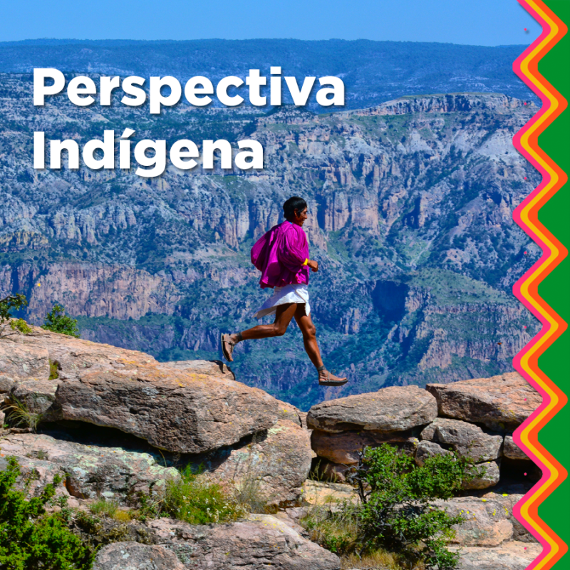 a man standing in front of a rocky mountain