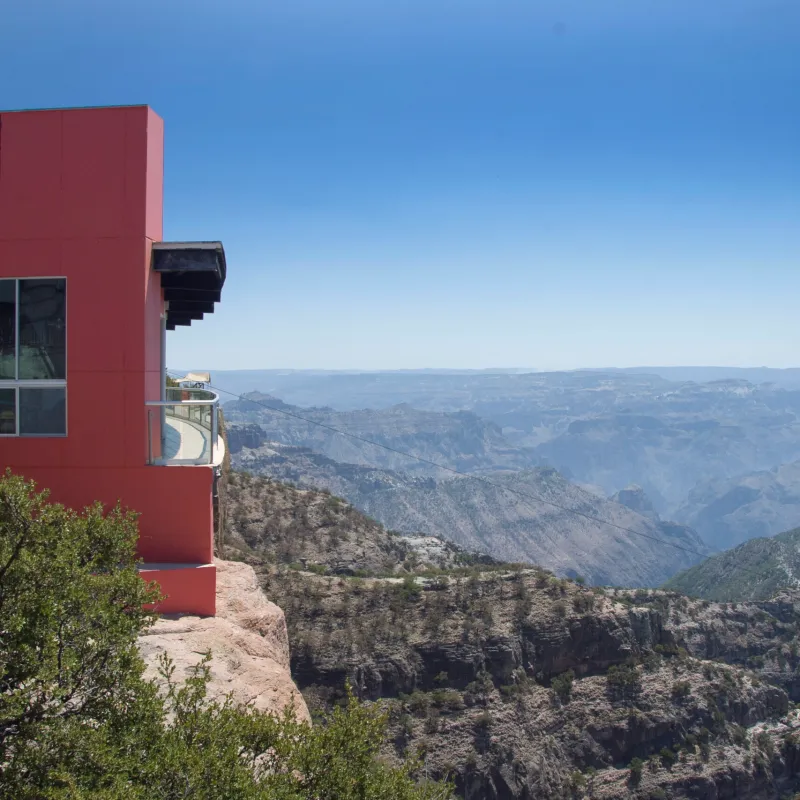 a large building with a mountain in the background